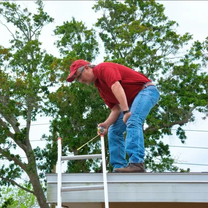 Roofing Estimator on Roof in West End