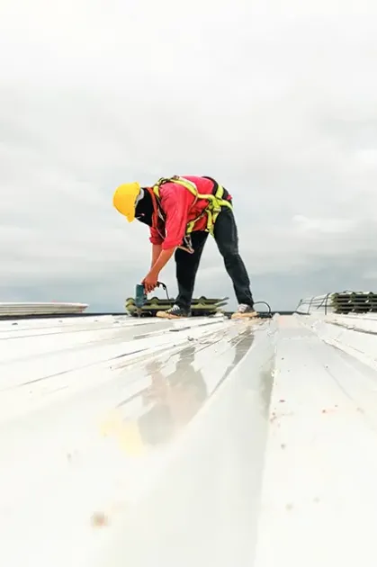 Commercial roofers on metal roof in Henrico